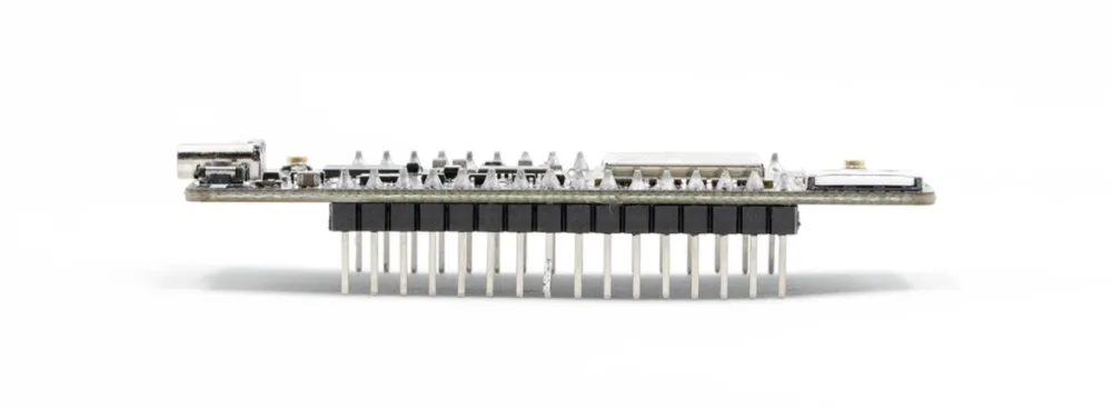 Side view of the Thinger32 NB-IoT with the 2.54 mm male pin headers under the board and the antenna connector at one end